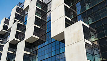Original white balconies in a glass facade and blue color with straight lines
