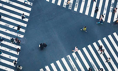 People walking on crossing city street crosswalk top view Japan