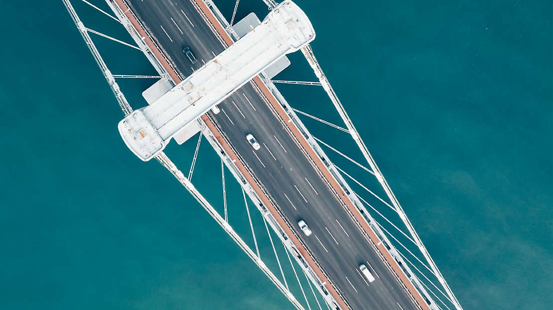 Aerial view of a bridge, over blue water