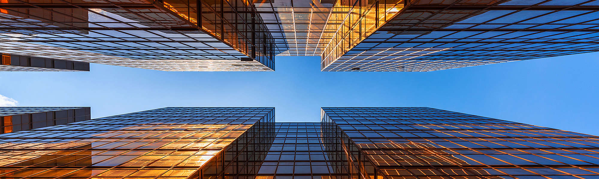 Golden building with blue sky. Windows glass of modern office skyscrapers. facade design. Architecture exterior for cityscape background.