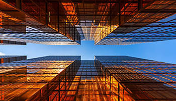 golden building looking up at the blue sky