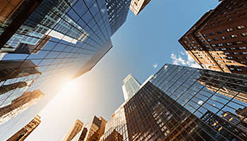 city skyscraper looking up to sunlight.