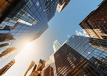 city skyscraper looking up to sunlight.