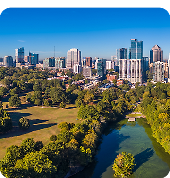 City skyline with a park and river upfront