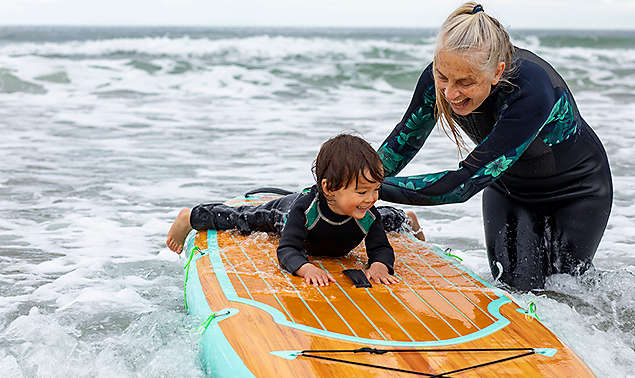 Woman and child surfing