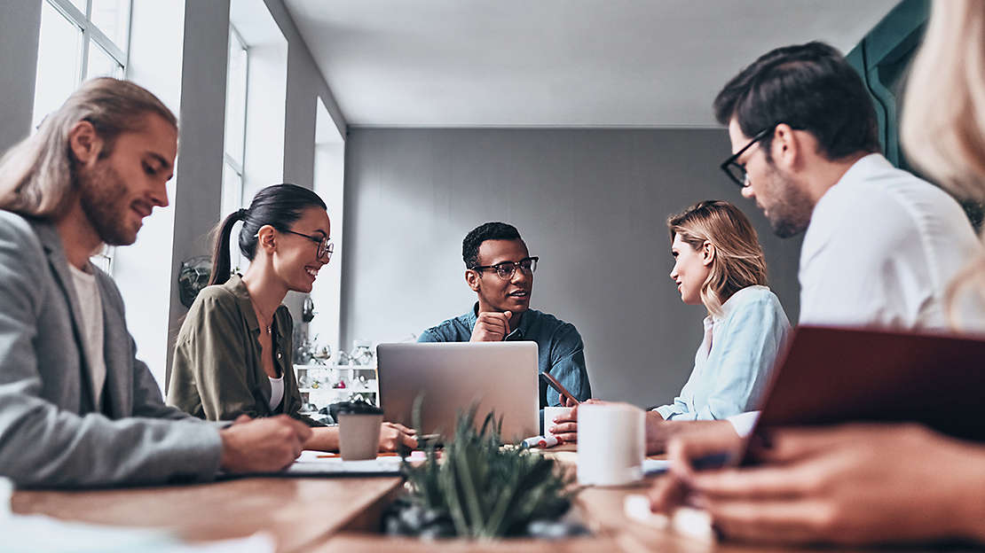 group of people around a conference table having a meeting