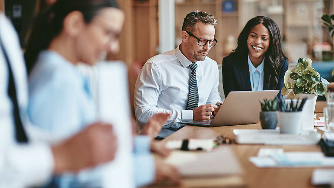 business people looking at laptop