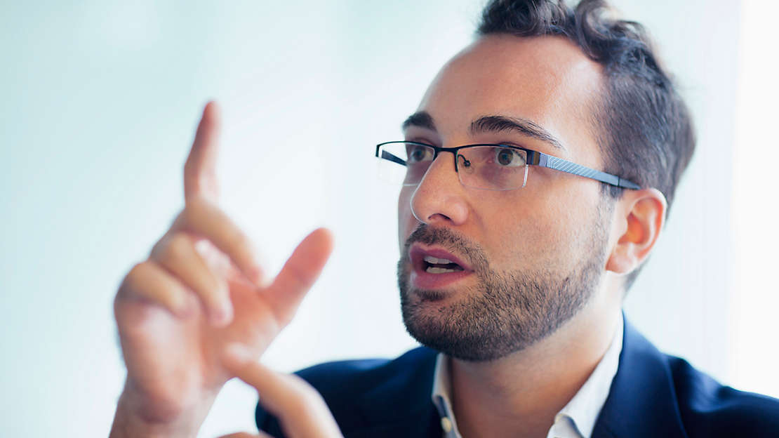 man with glasses talking hands